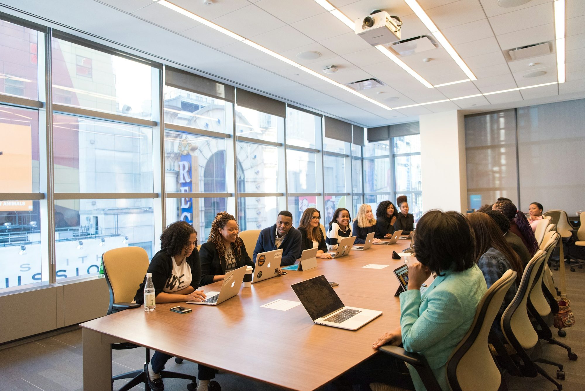 A management team meeting around a long boardroom table